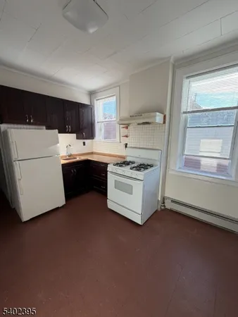 a kitchen with a stove and a refrigerator