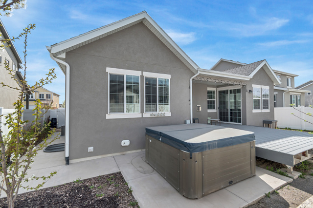 3232 West 1670th Street North Provo, UT 84601 - Photo 3 of 33 Rear view of property with stucco siding and a hot tub