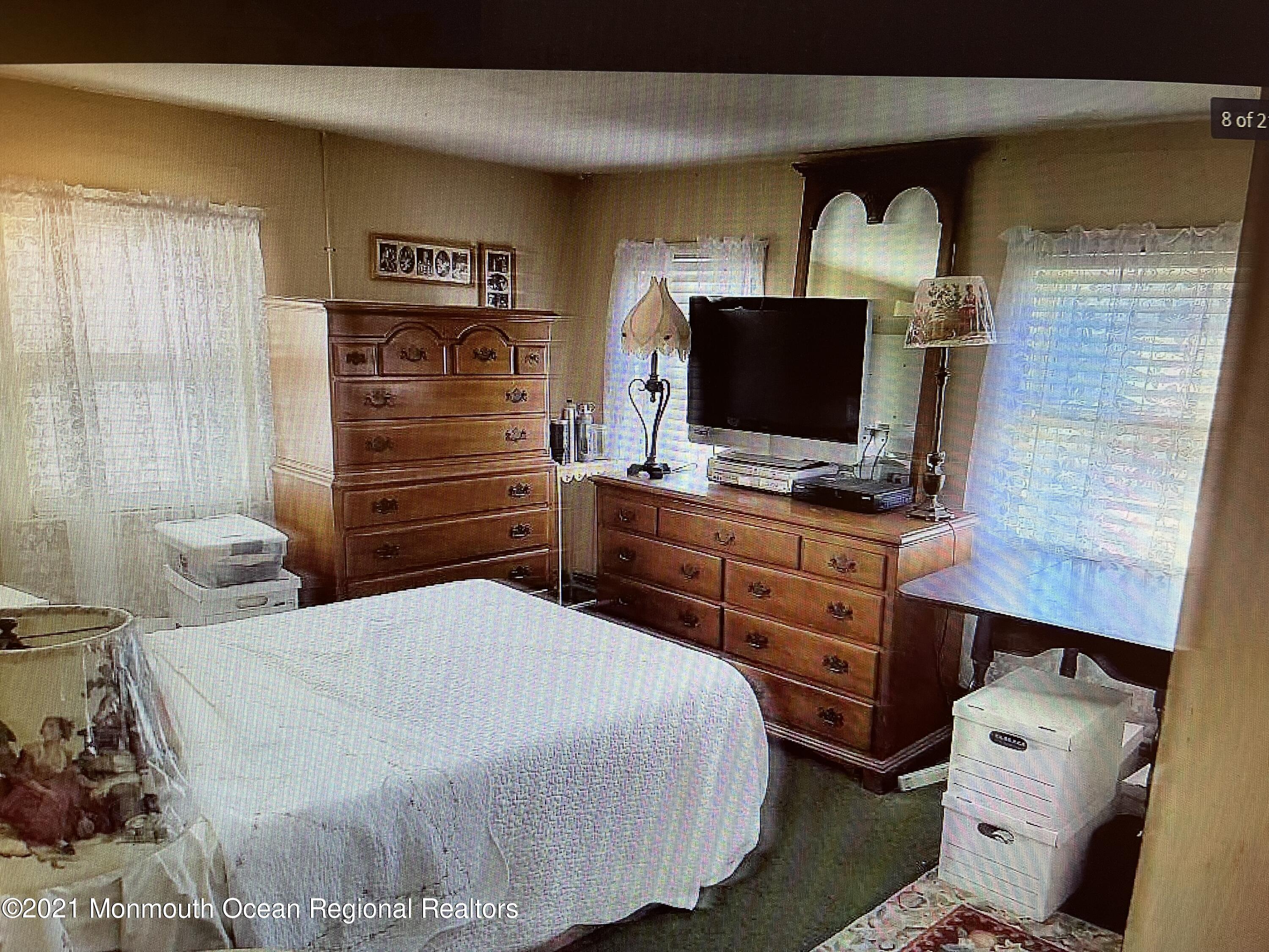 803 Wall Road Spring Lake Heights, NJ 07762 - Photo 5 of 9 a bedroom with a bed and a flat screen tv
