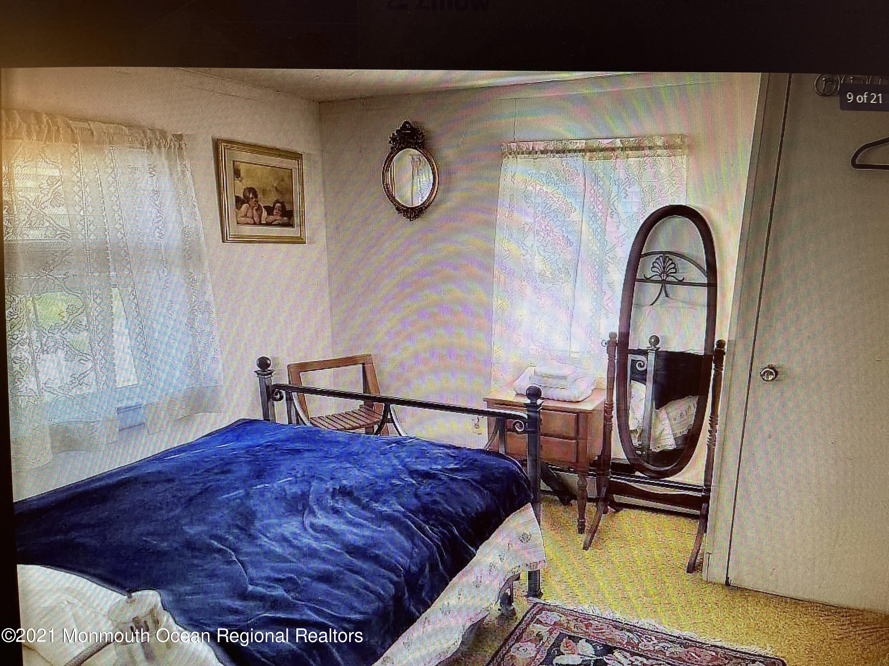 803 Wall Road Spring Lake Heights, NJ 07762 - Photo 6 of 9 a bedroom with a bed and a table in it
