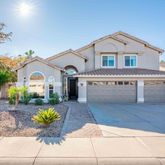 a front view of a house with a yard and outdoor seating