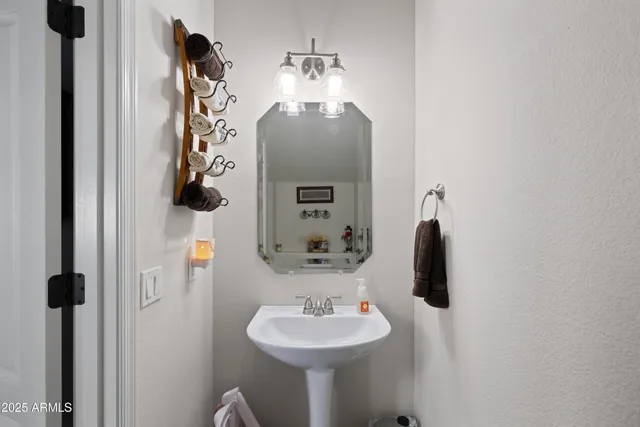 a bathroom with a sink and mirror