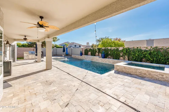 a view of a patio with a table and chairs under an umbrella