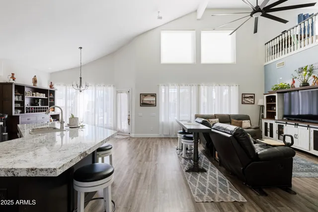 a living room with furniture a flat screen tv and a large window
