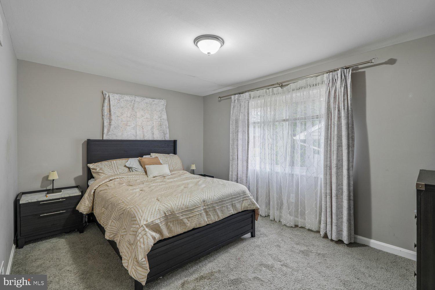 10128 Dallas Avenue Silver Spring, MD 20901 - Photo 14 of 29 a large bed sitting in a bedroom next to a window