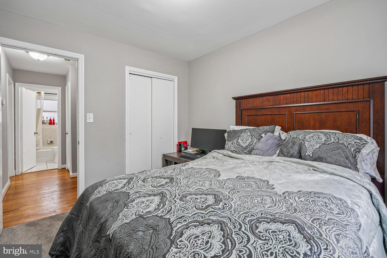 10128 Dallas Avenue Silver Spring, MD 20901 - Photo 21 of 29 a bedroom with a large bed and wooden floor