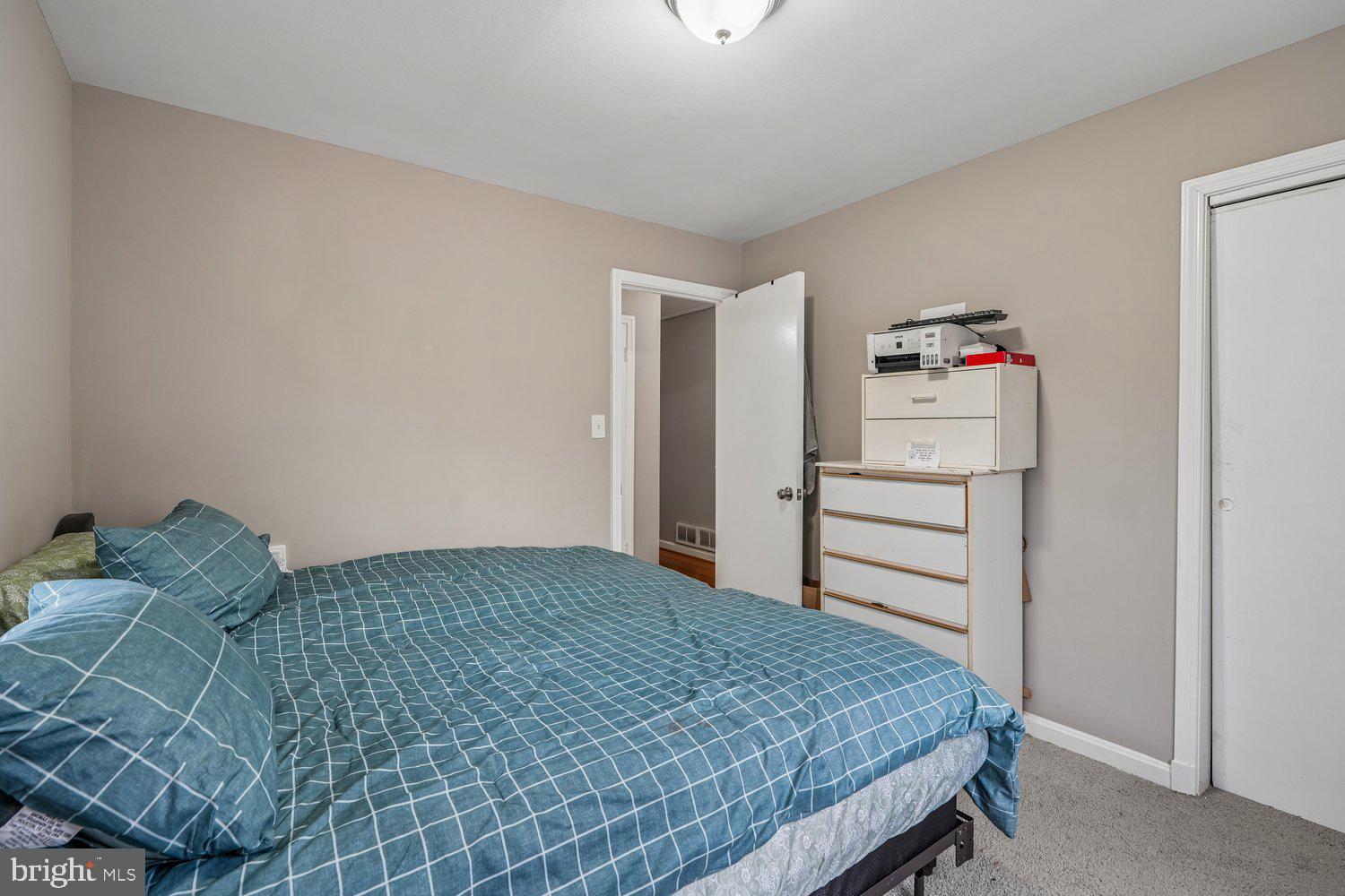 10128 Dallas Avenue Silver Spring, MD 20901 - Photo 24 of 29 a bedroom with a bed and a cabinets