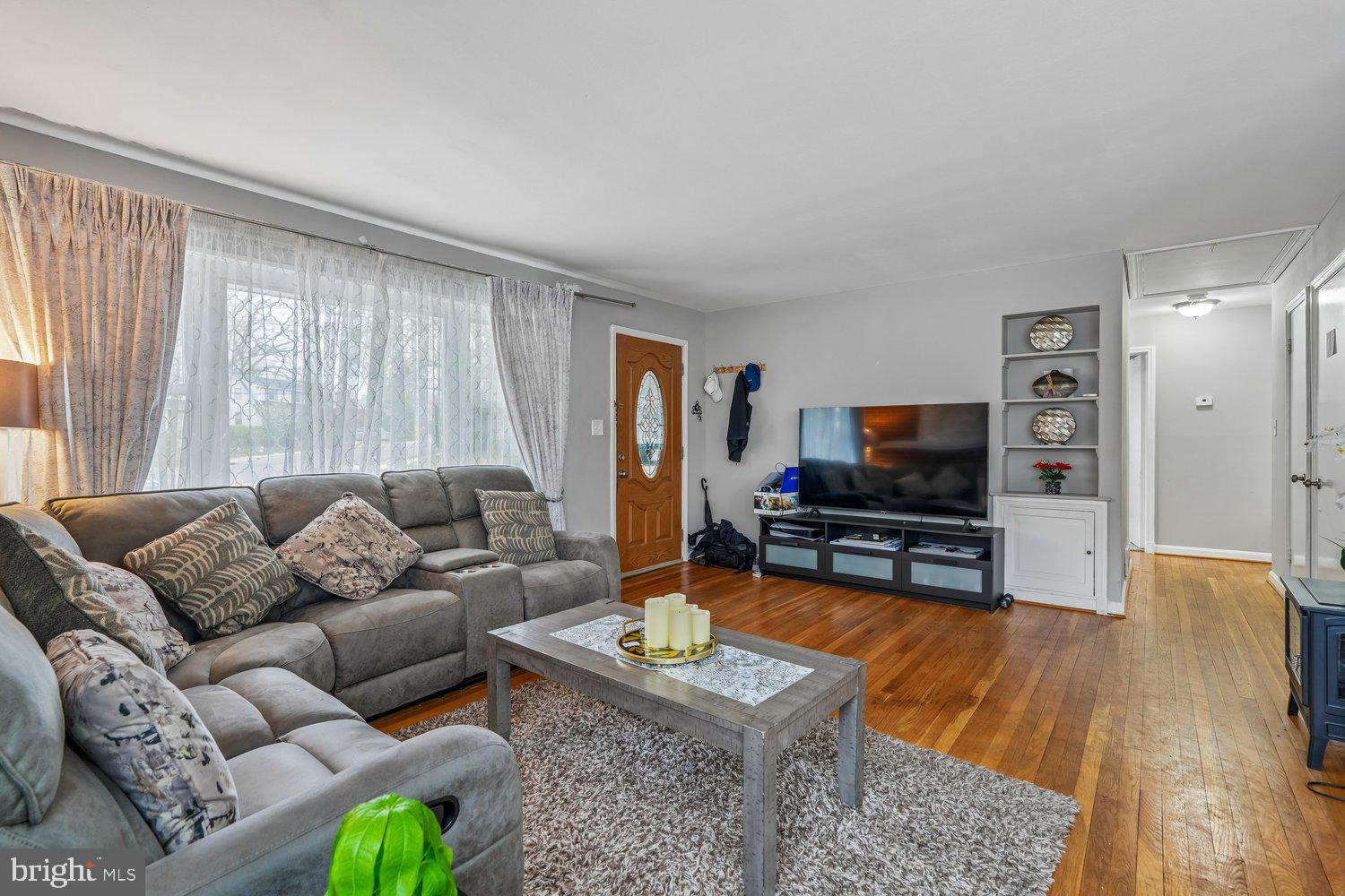 10128 Dallas Avenue Silver Spring, MD 20901 - Photo 5 of 29 a living room with furniture and a flat screen tv