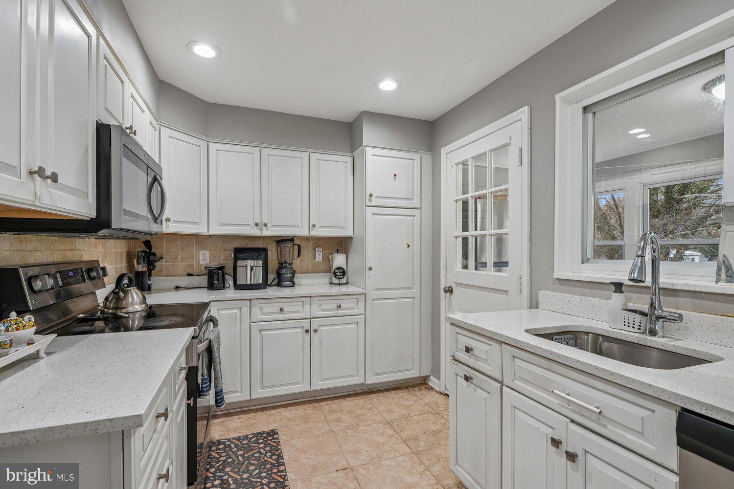 10128 Dallas Avenue Silver Spring, MD 20901 - Photo 8 of 29 a kitchen with sink cabinets and window