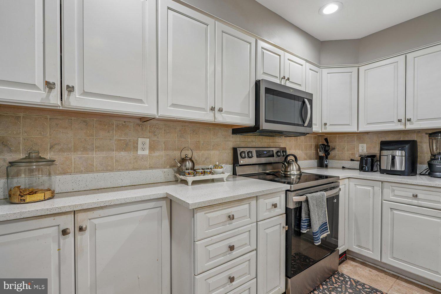 10128 Dallas Avenue Silver Spring, MD 20901 - Photo 9 of 29 a kitchen with stainless steel appliances granite countertop white cabinets a sink and dishwasher