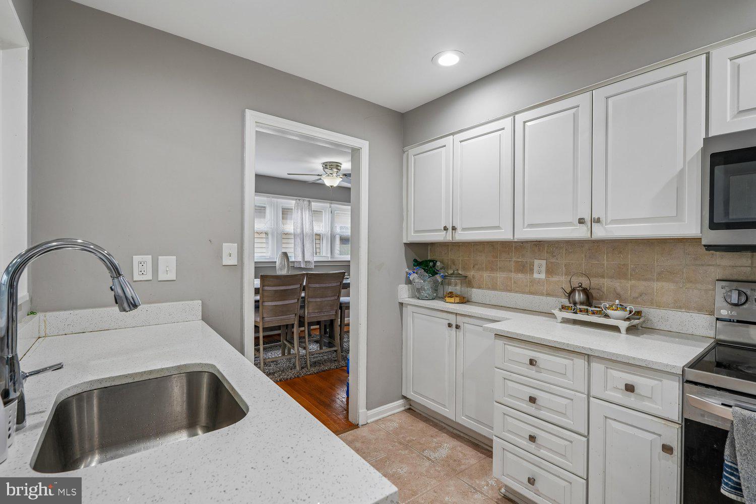 10128 Dallas Avenue Silver Spring, MD 20901 - Photo 10 of 29 a kitchen with granite countertop a sink a stove and cabinets