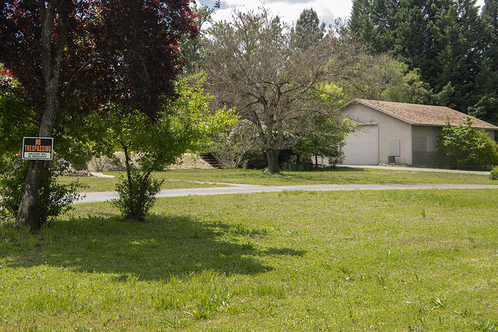 0 Lower River Road, Unit TL#108 Grants Pass, OR 97526 - Photo 4 of 47 a view of a house with a big yard and large trees