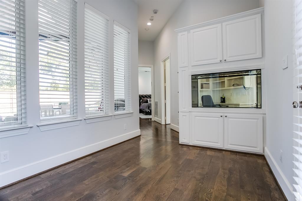6319 Turner Way Dallas, TX 75230 - Photo 12 of 36 an empty room with wooden floor and cabinet