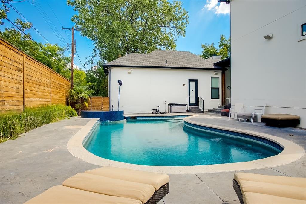 6319 Turner Way Dallas, TX 75230 - Photo 27 of 36 a view of a swimming pool with a chair and tables in the patio