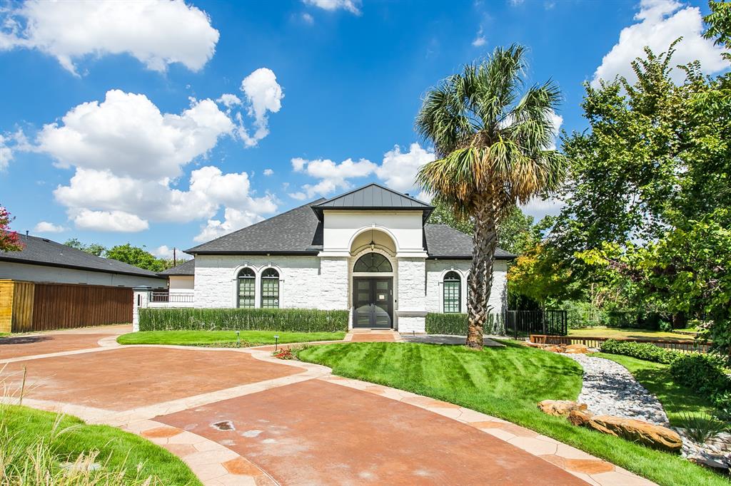 6319 Turner Way Dallas, TX 75230 - Photo 36 of 36 a front view of a house with a garden and a tree