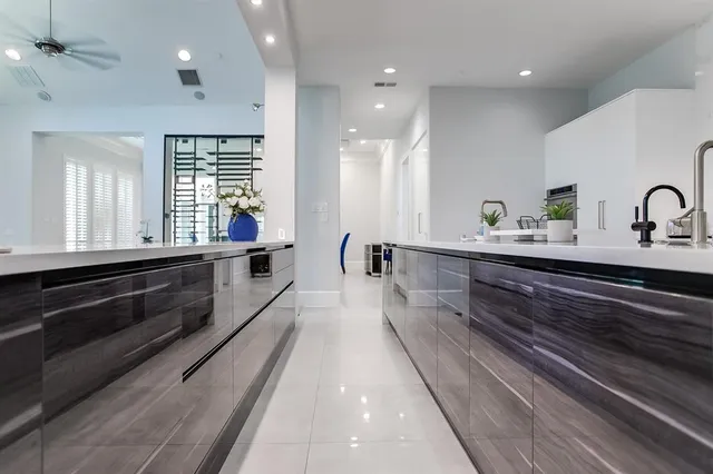 a large kitchen with kitchen island a sink stainless steel appliances and a counter space