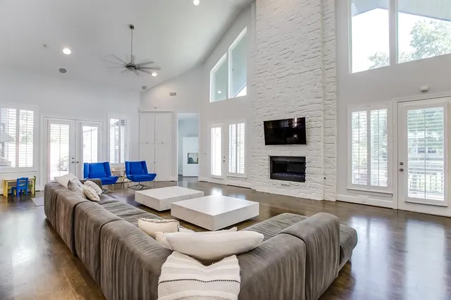 a living room with fireplace furniture and a flat screen tv