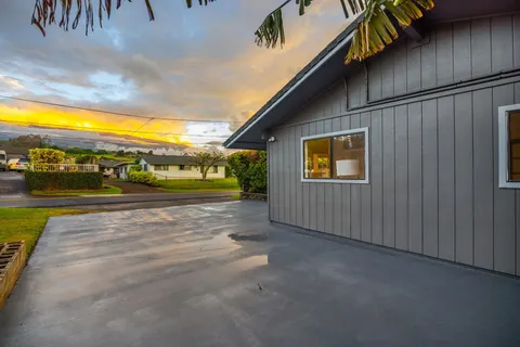 a backyard of a house with table and chairs