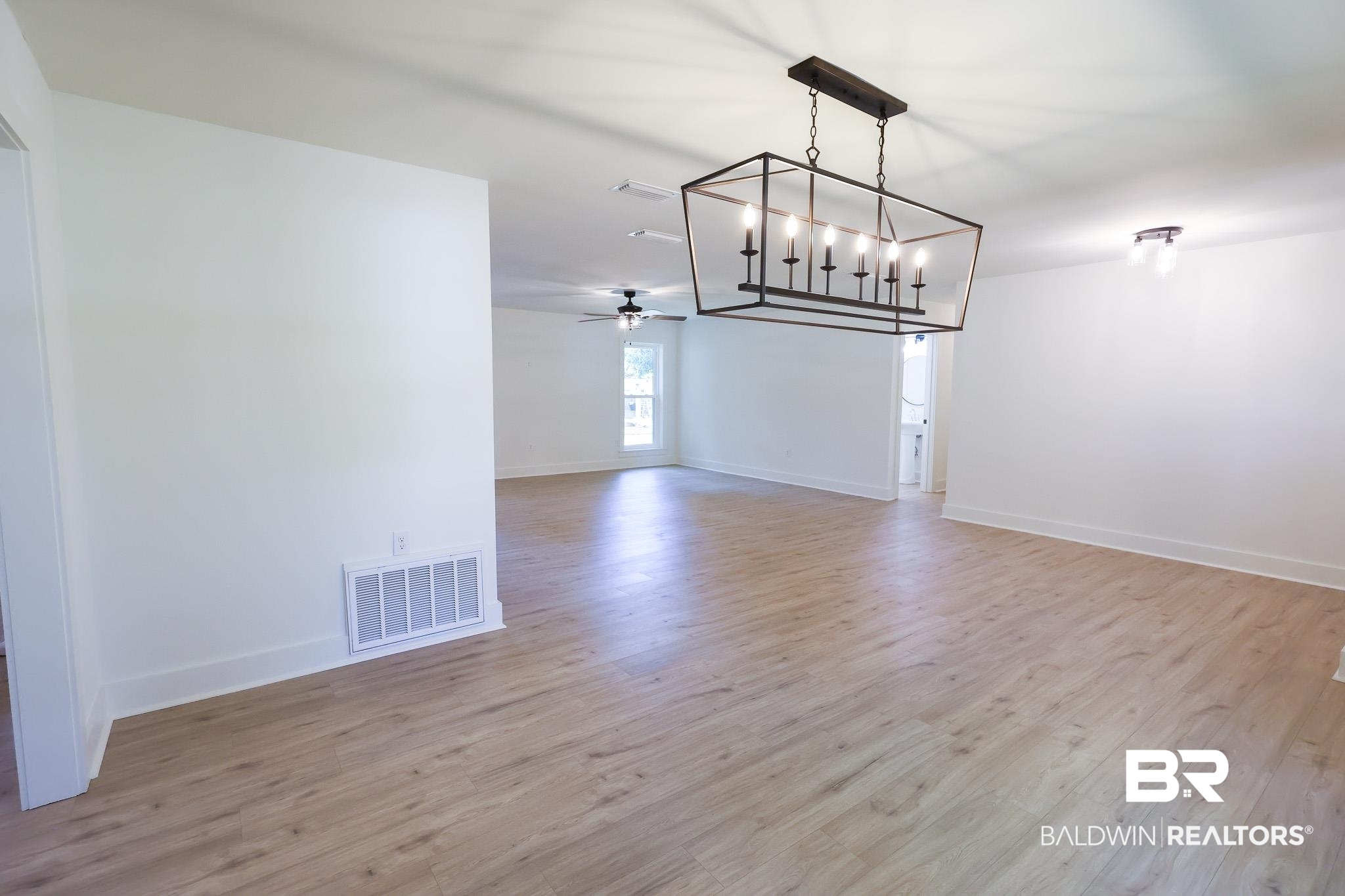 12190 Pecan Grove Street Magnolia Springs, AL 36555 - Photo 10 of 45 Unfurnished dining area with light hardwood / wood-style flooring and ceiling fan with notable chandelier
