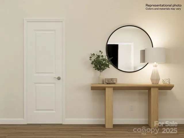 a kitchen with stainless steel appliances a table chairs in it and wooden floors