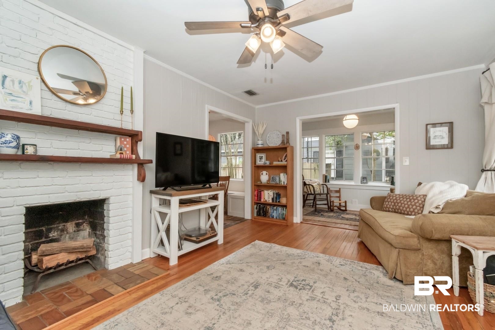 113 Ellinor Street Mobile, AL 36606 - Photo 3 of 28 Living room with visible vents, wood finished floors, a fireplace, crown molding, and ceiling fan