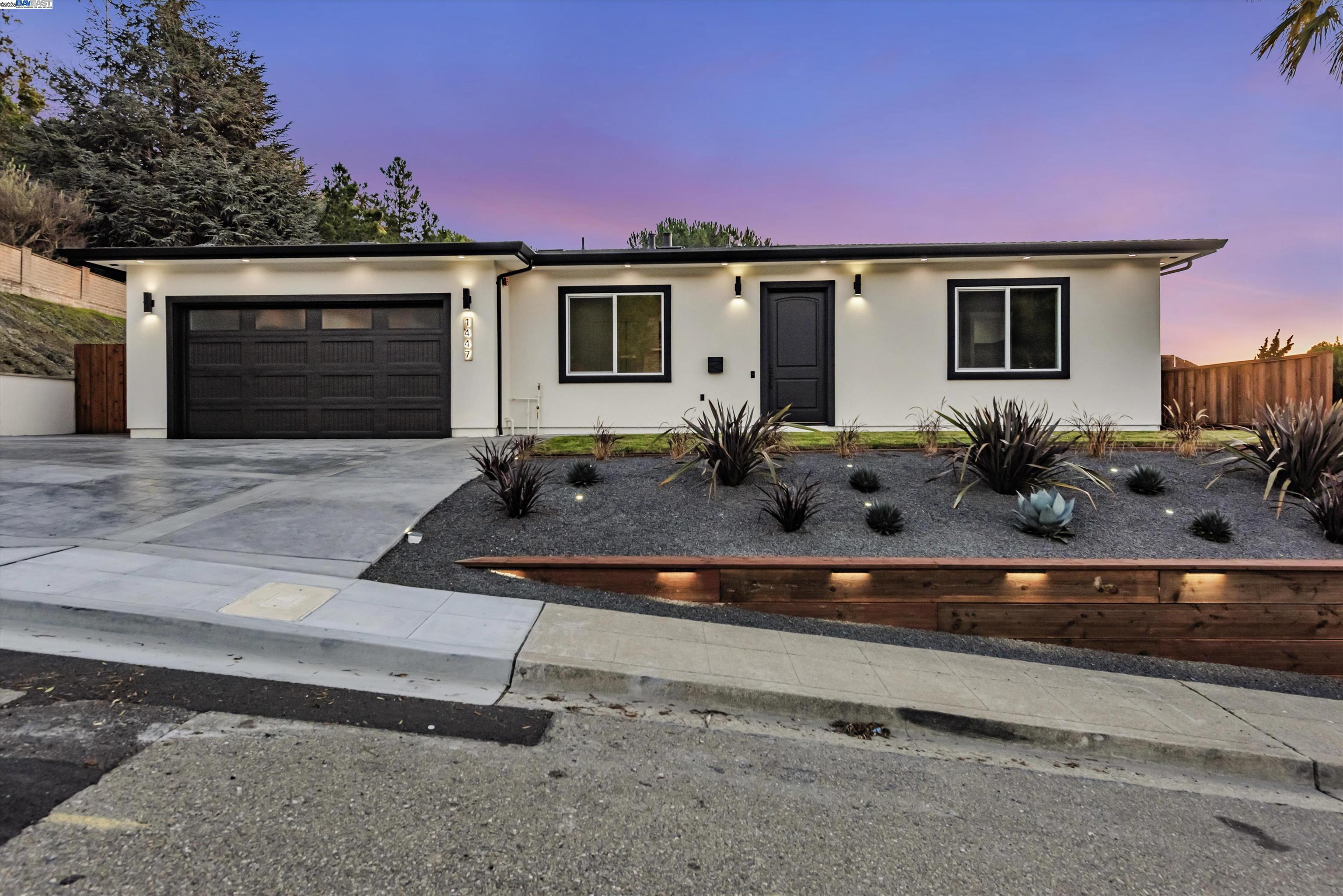 a front view of house with yard outdoor seating and covered with trees