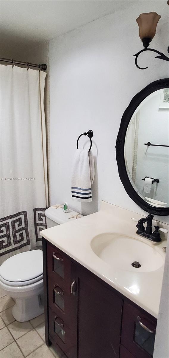 1720 Harrison Street, Unit 10G Hollywood, FL 33020 - Photo 13 of 20 a bathroom with a sink a toilet and mirror