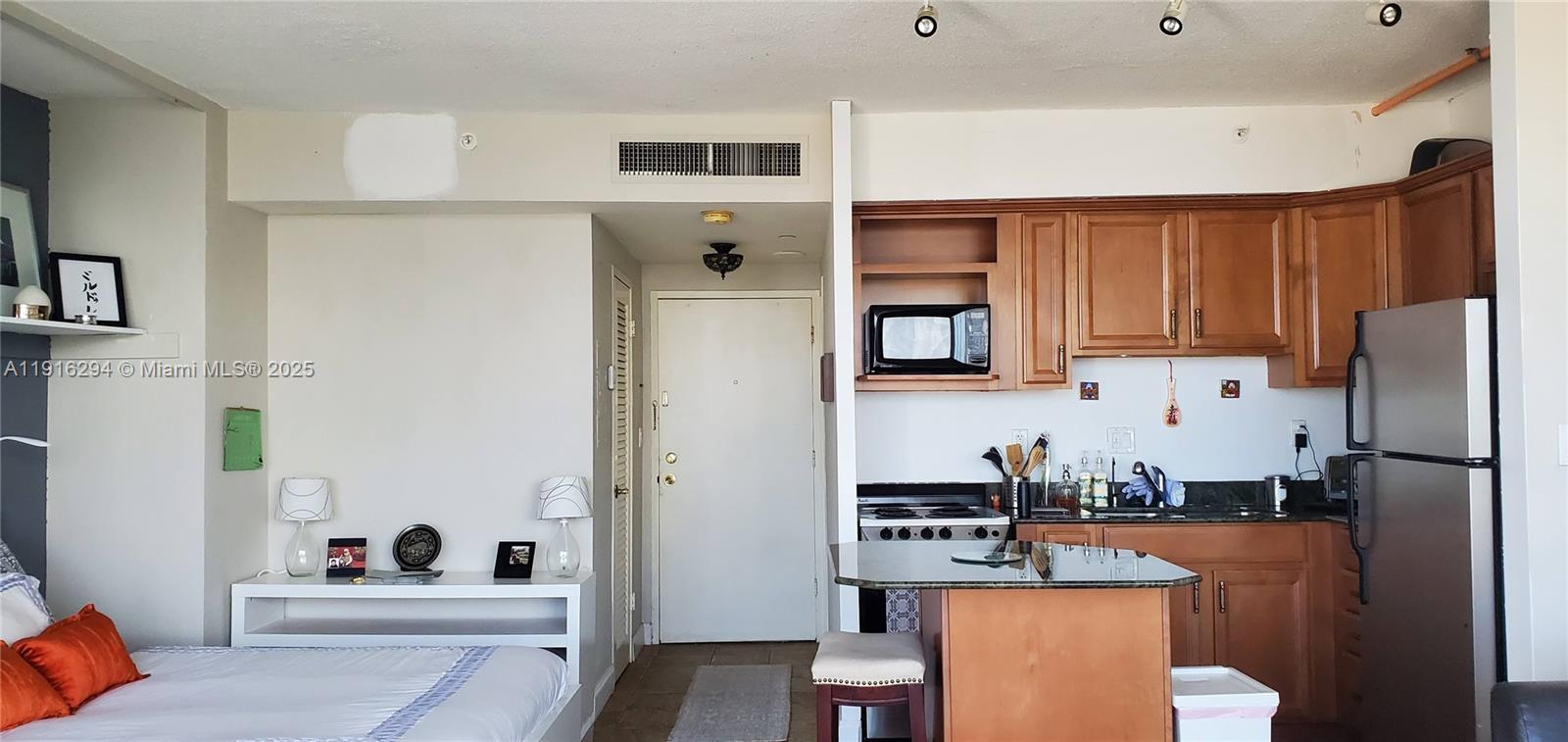 1720 Harrison Street, Unit 10G Hollywood, FL 33020 - Photo 7 of 20 a kitchen with stainless steel appliances a refrigerator a sink a stove and white cabinets