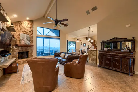 a living room with furniture a fireplace and a flat screen tv