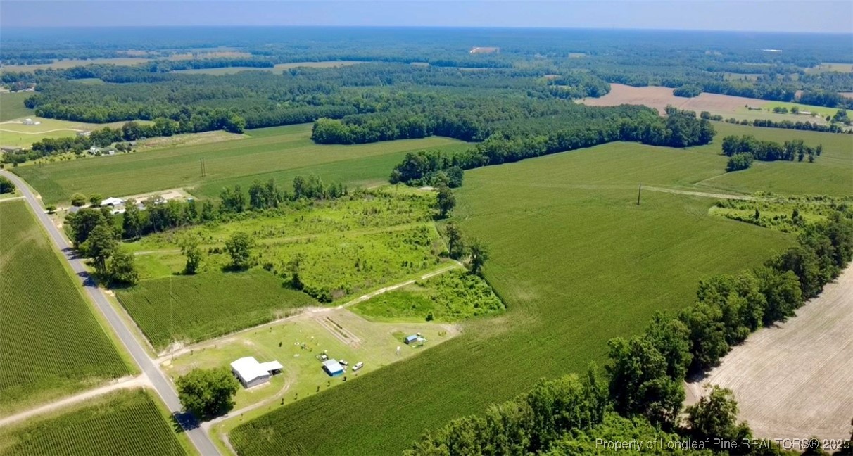 an aerial view of a houses with a yard