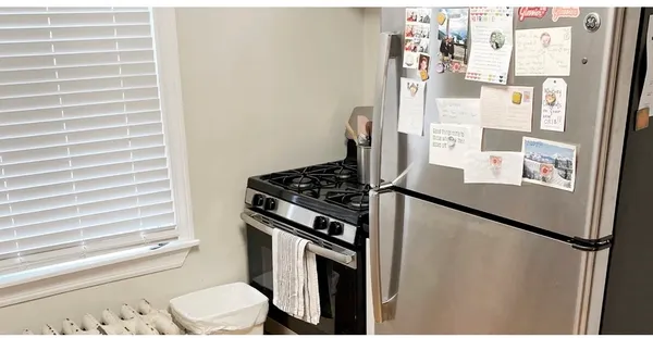 a kitchen with a refrigerator and a stove