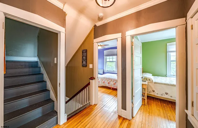 a bedroom with a bed dresser and a large window