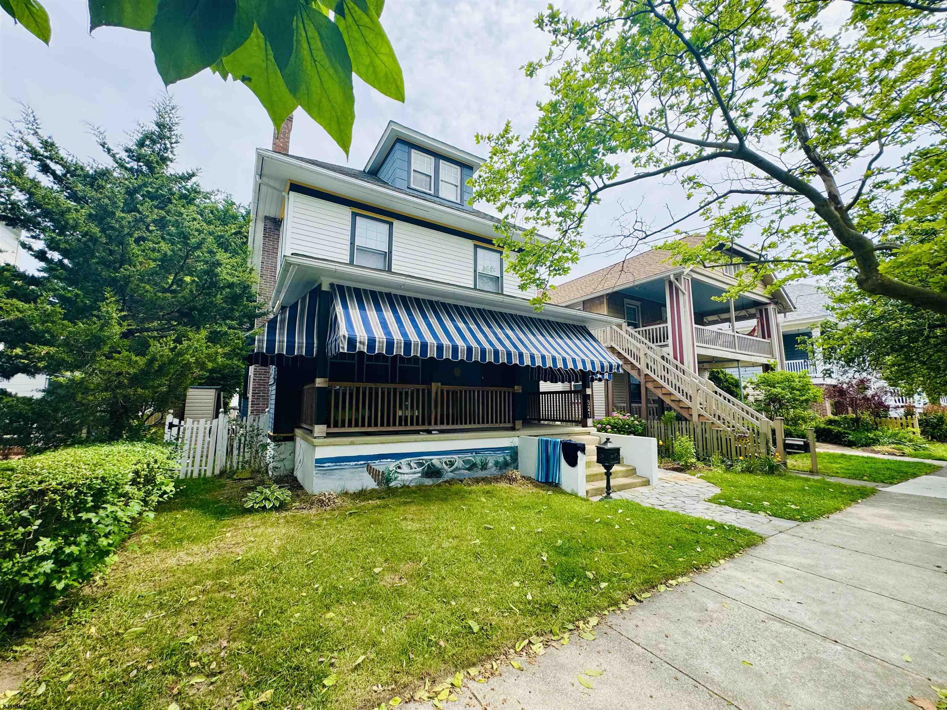 321 Central Avenue Ocean City, NJ 08226 - Photo 2 of 61 a view of a house with a yard deck and a large tree