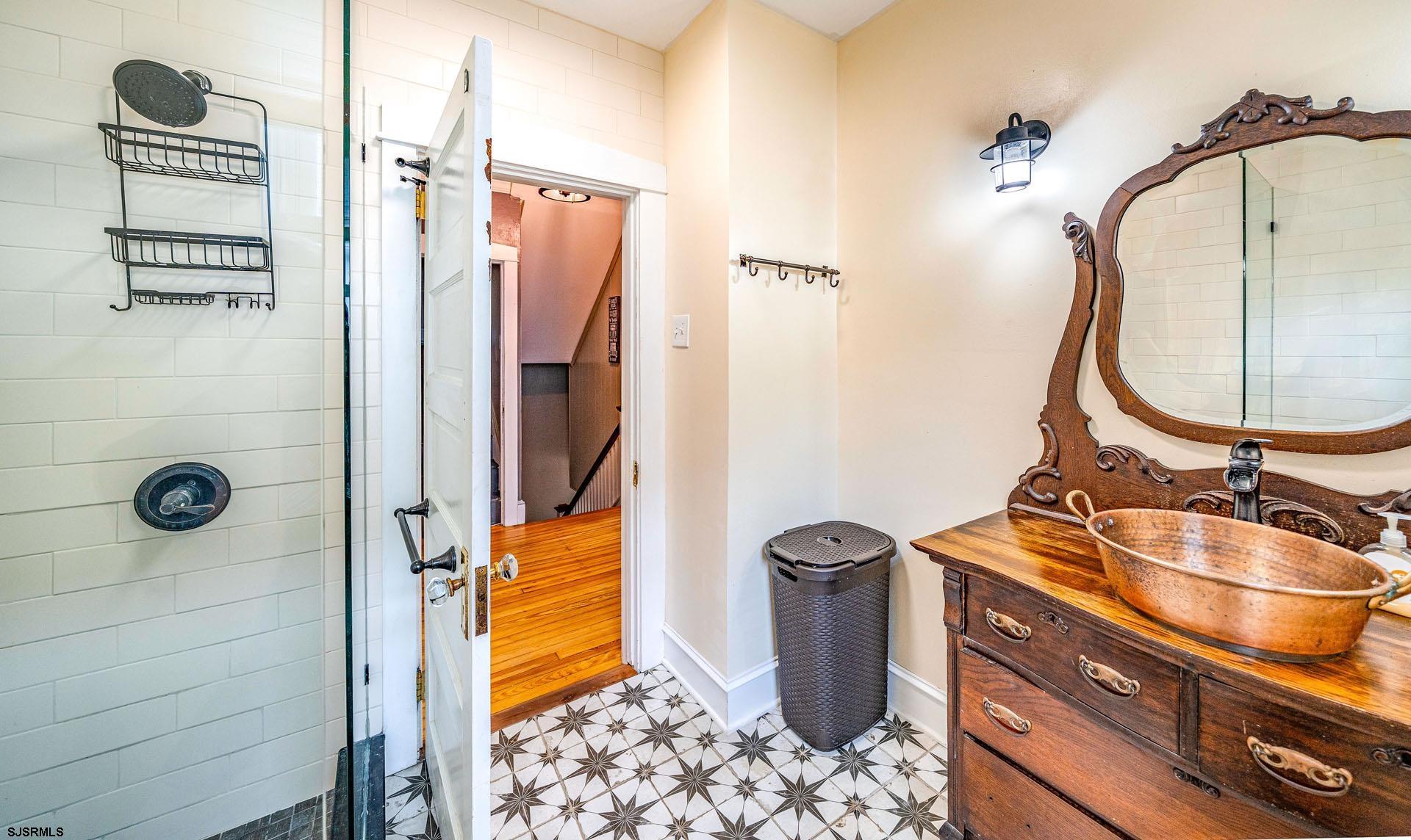 321 Central Avenue Ocean City, NJ 08226 - Photo 22 of 61 a bathroom with a sink a granite and mirror