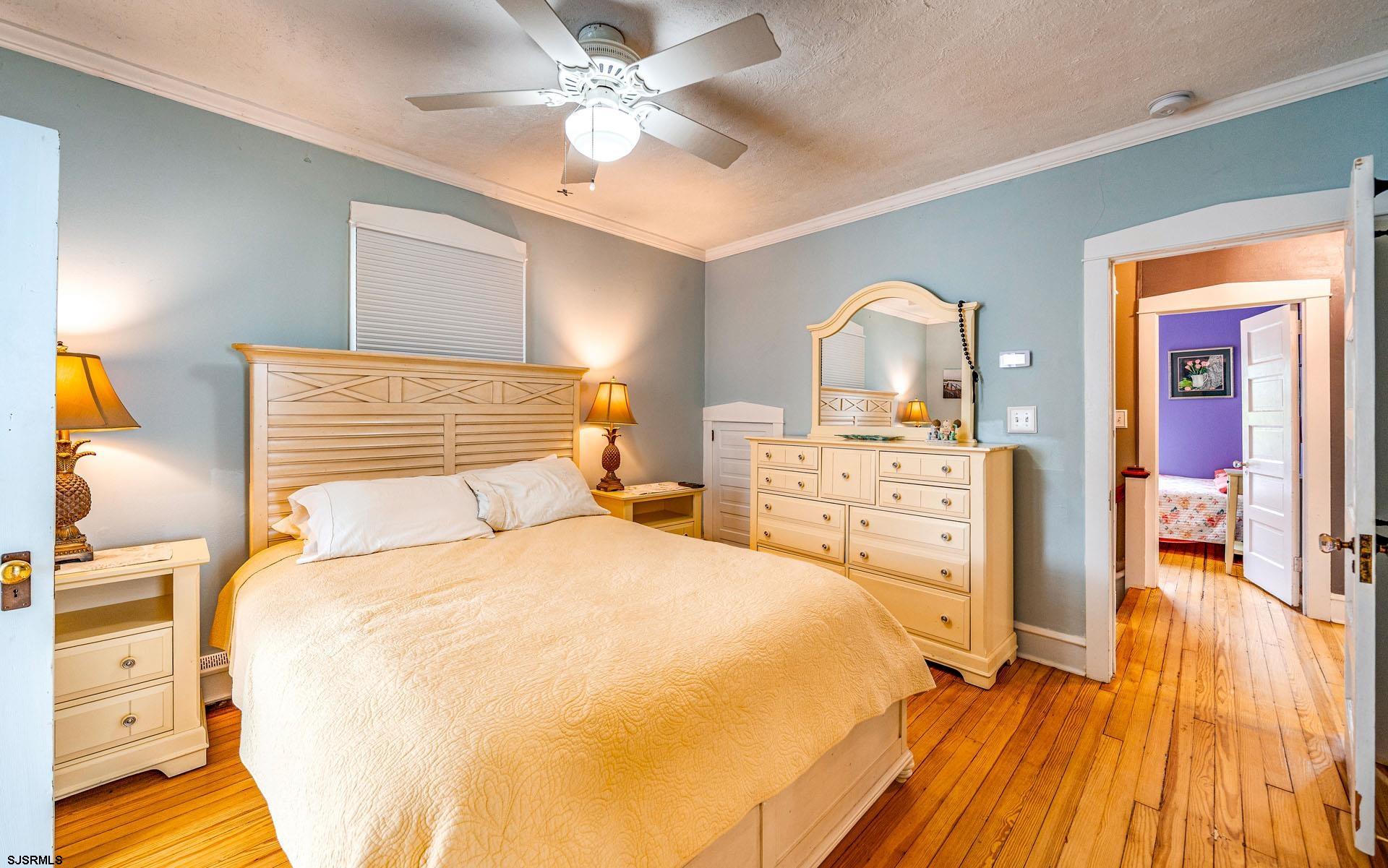 321 Central Avenue Ocean City, NJ 08226 - Photo 24 of 61 a bedroom with a bed and a chandelier