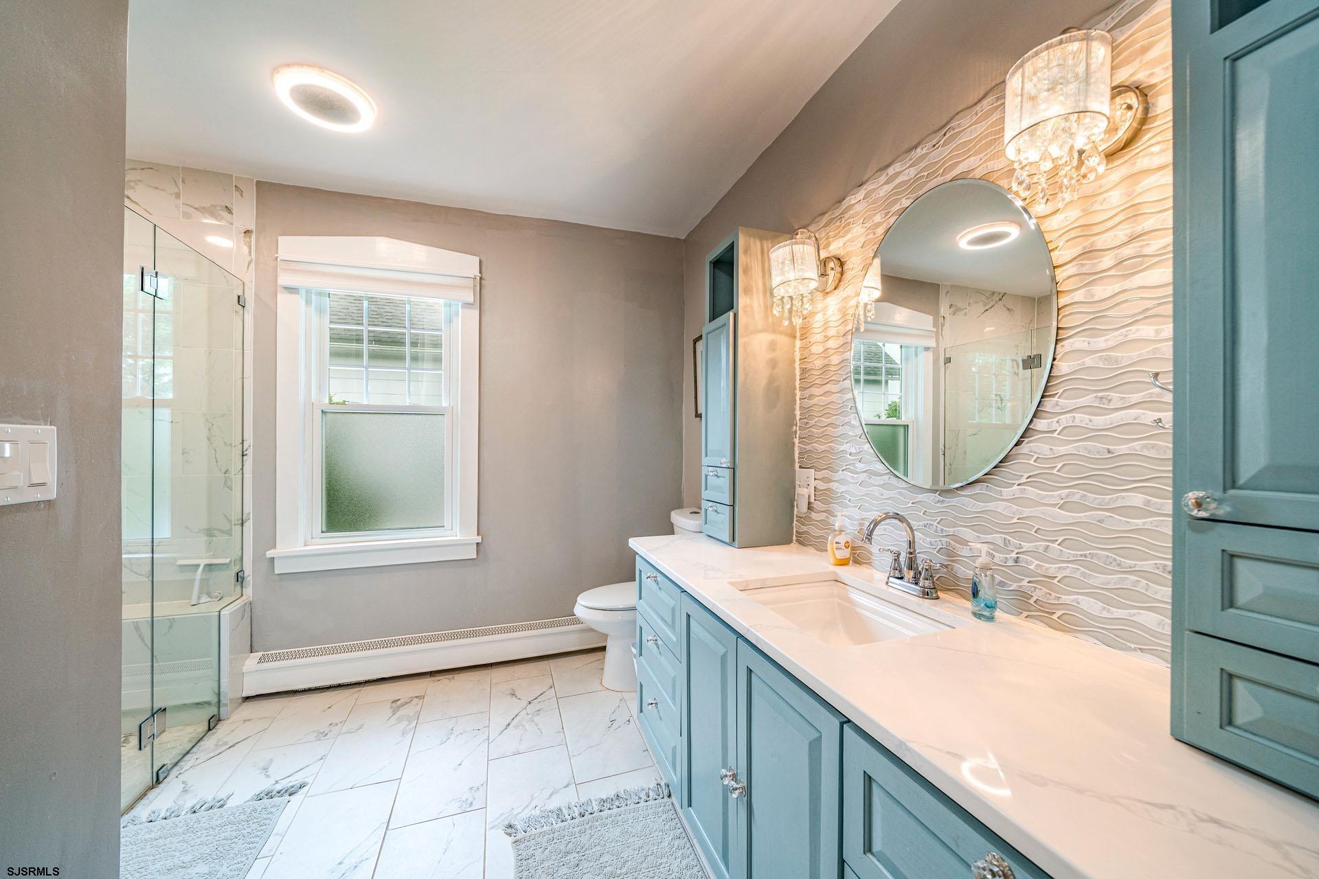 321 Central Avenue Ocean City, NJ 08226 - Photo 26 of 61 a bathroom with a double vanity sink and a mirror