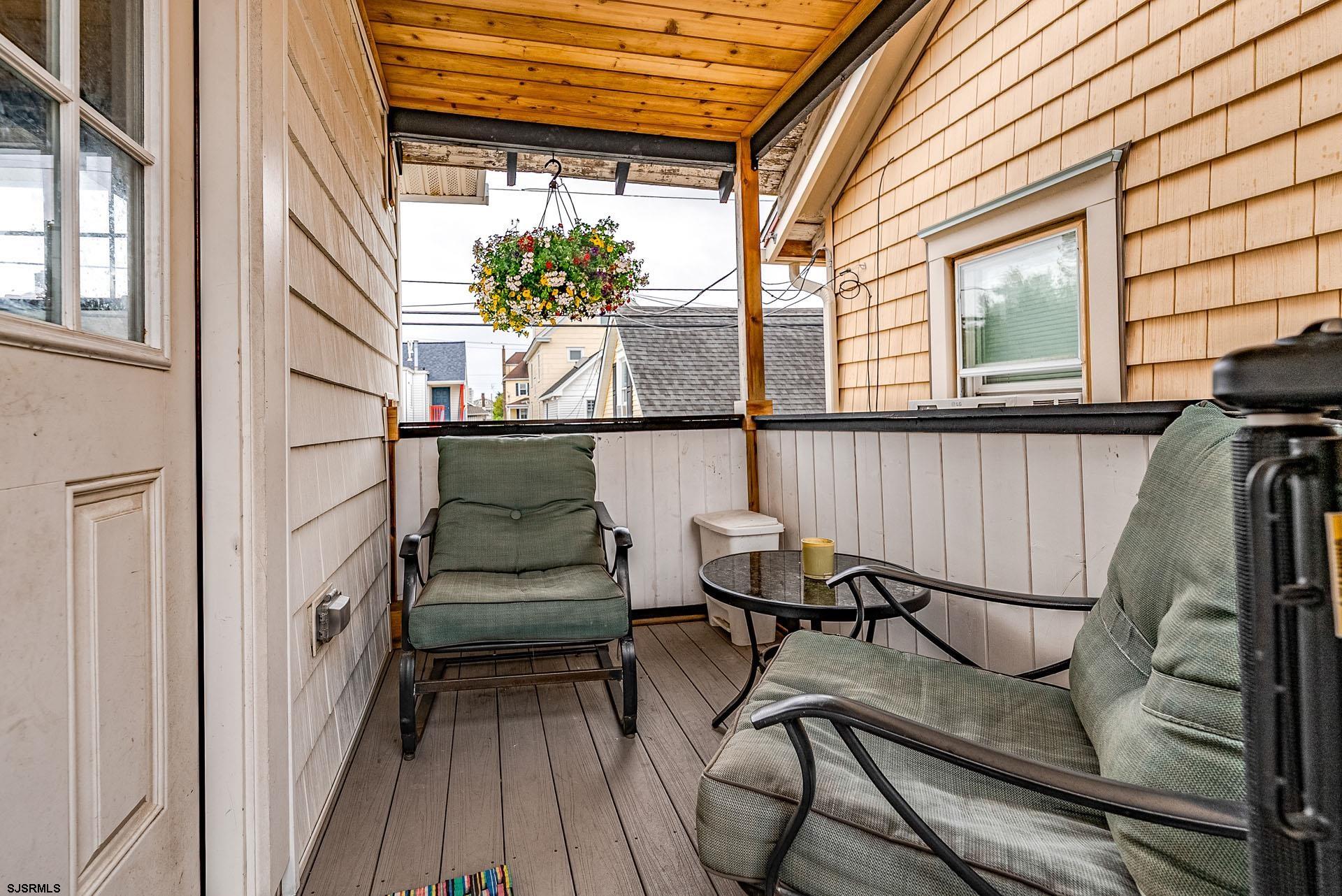 321 Central Avenue Ocean City, NJ 08226 - Photo 37 of 61 a balcony view with couple of chairs and wooden floor