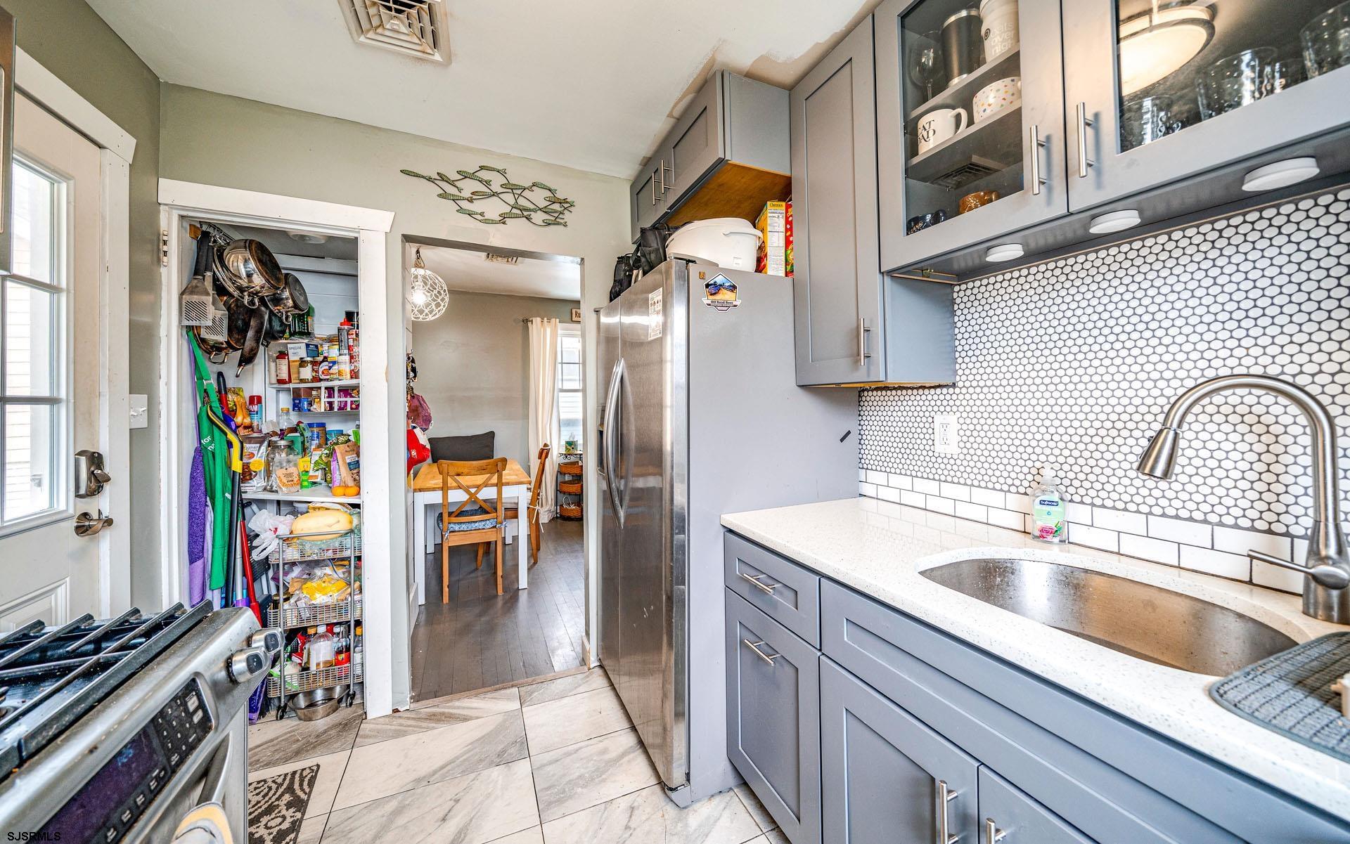 321 Central Avenue Ocean City, NJ 08226 - Photo 41 of 61 a kitchen with stainless steel appliances granite countertop a refrigerator and a sink