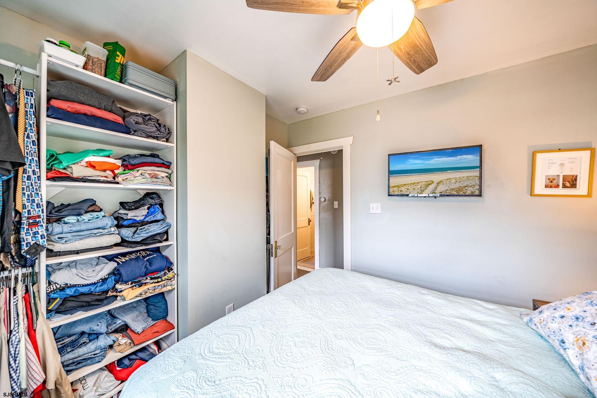 321 Central Avenue Ocean City, NJ 08226 - Photo 44 of 61 a bedroom with a bed and a book shelf
