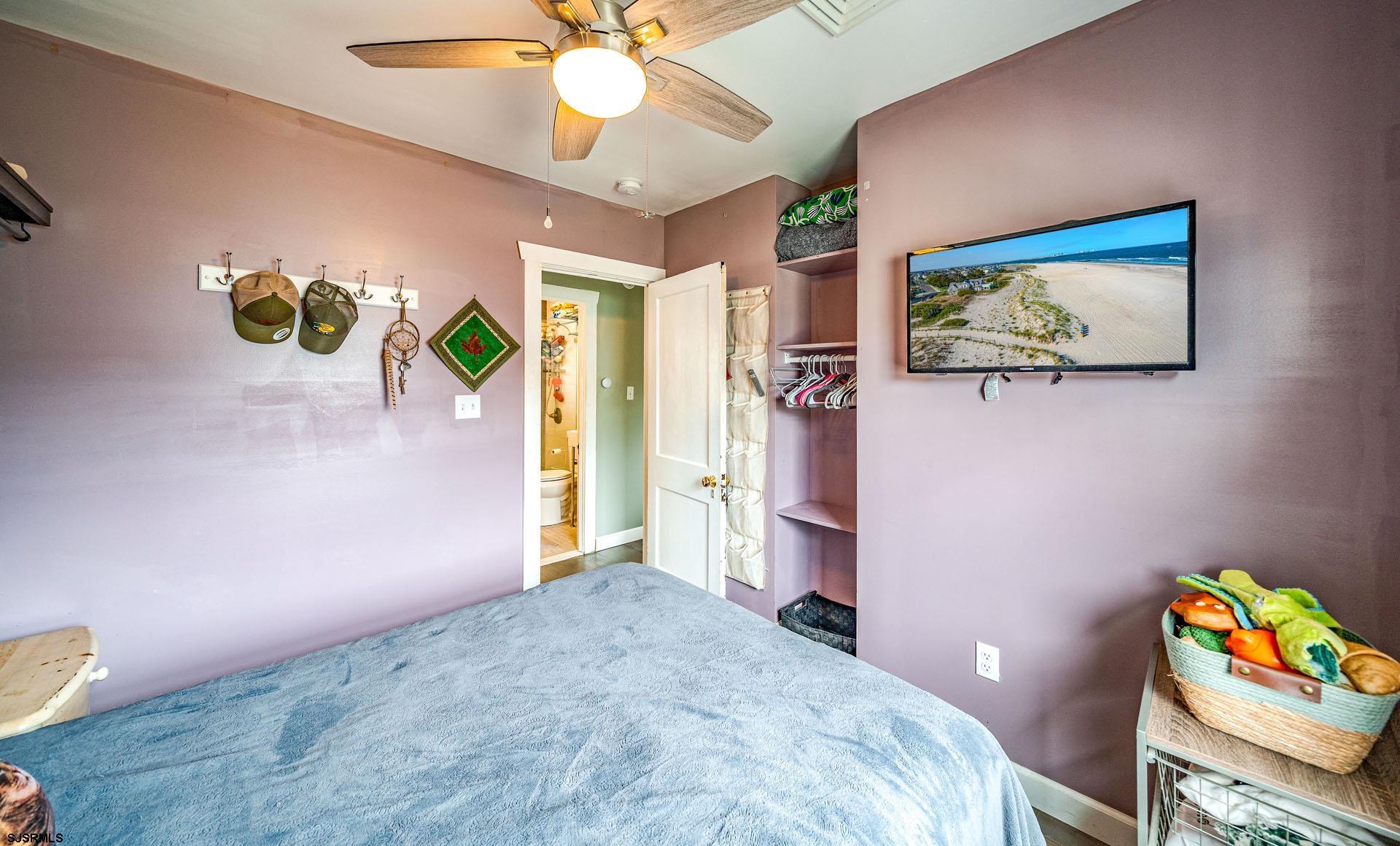 321 Central Avenue Ocean City, NJ 08226 - Photo 46 of 61 a bedroom with a bed and a chandelier