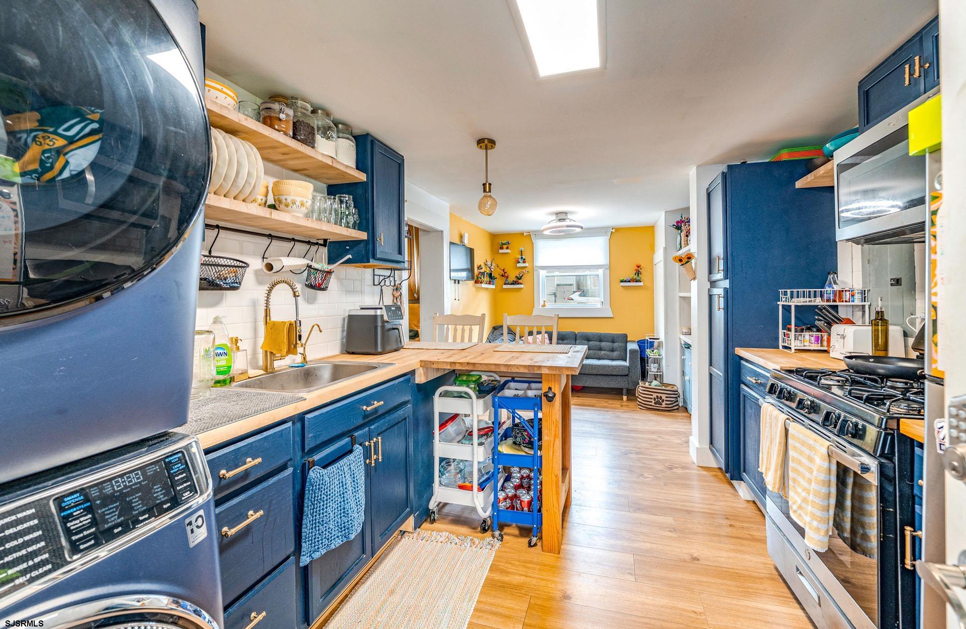 321 Central Avenue Ocean City, NJ 08226 - Photo 50 of 61 a kitchen with lots of counter top space and wooden floor