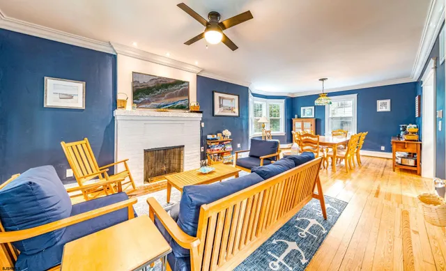 a living room with furniture kitchen view and a large window