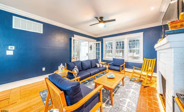 a living room with furniture and a ceiling fan