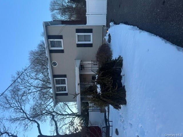 a view of a house with a yard and sitting area