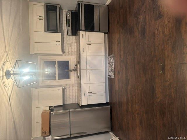 67 St George Drive Shirley, NY 11967 - Photo 3 of 11 a kitchen with kitchen island granite countertop a refrigerator and a stove top oven