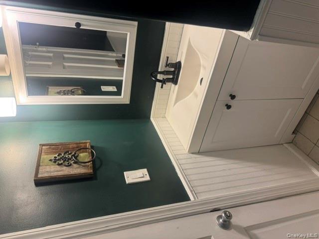 67 St George Drive Shirley, NY 11967 - Photo 5 of 11 a bathroom with a sink and a mirror