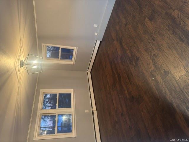 67 St George Drive Shirley, NY 11967 - Photo 6 of 11 an empty room with wooden floor and windows