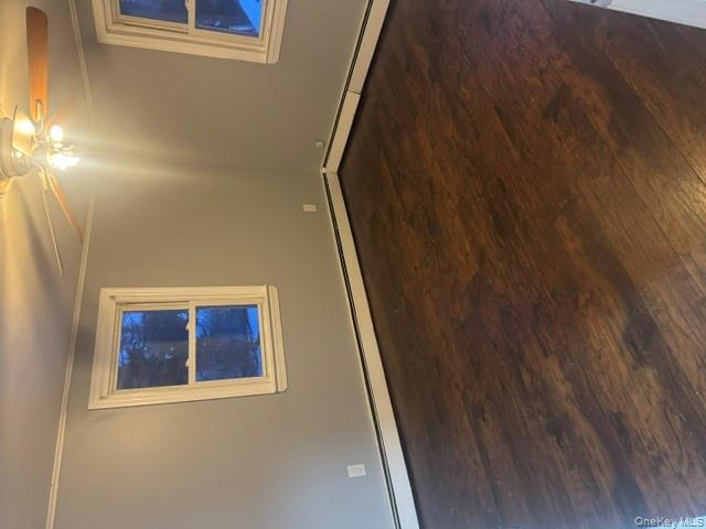 67 St George Drive Shirley, NY 11967 - Photo 7 of 11 an empty room with wooden floor and windows