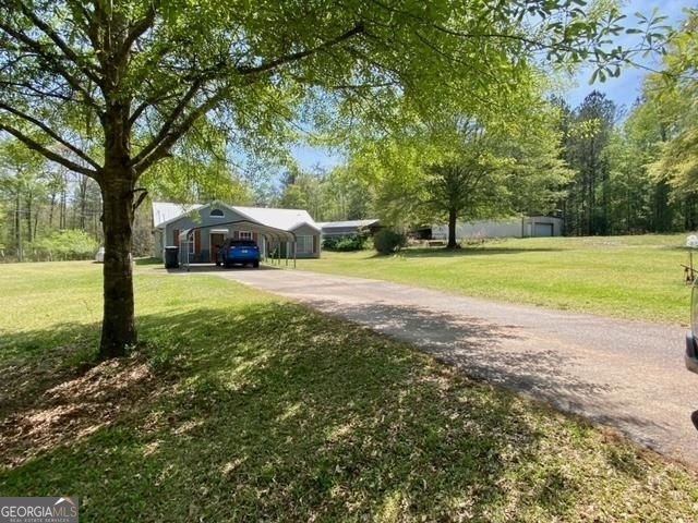 1548 Sullivan Mill Road Senoia, GA 30276 - Photo 1 of 1 a view of a house with big yard and large trees