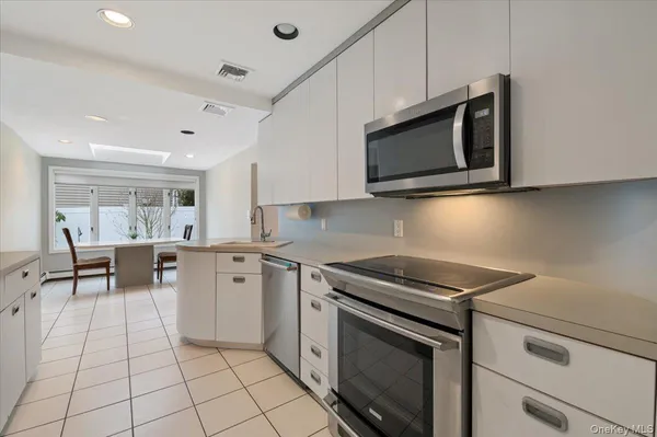 a kitchen with stainless steel appliances a stove microwave and cabinets